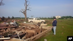 A Tuesday morning photo shows Larry Nelson, 73, as he surveys what’s left of his home after Monday's tornadoes struck Pilger, Nebraska, June 17, 2014. 