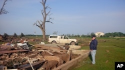 A Tuesday morning photo shows Larry Nelson, 73, as he surveys what’s left of his home after Monday's tornadoes struck Pilger, Nebraska, June 17, 2014.