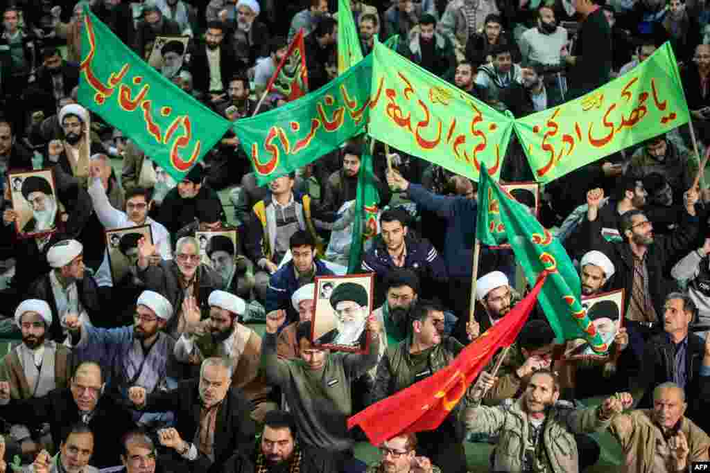 Iranians chant slogans as they march in support of the government near the Imam Khomeini grand mosque in the capital Tehran, Iran, Dec. 30, 2017.