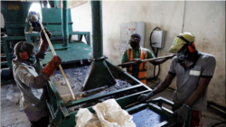 Men work on the recycling line of used car tires at the Freetown waste management recycle factory in Ibadan, Nigeria September 17, 2021. REUTERS/Temilade Adelaja