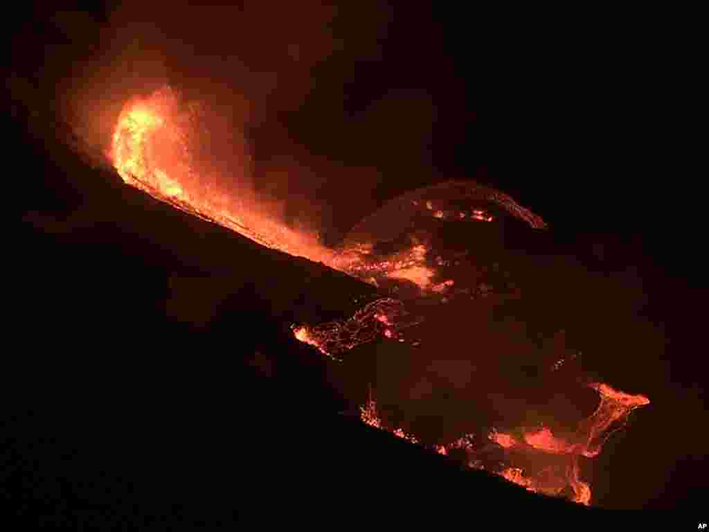 In this image provided by the U.S. Geological Survey, lava flows from the Halema’uma’u crater of the Kilauea volcano in Hawaii, Dec. 20, 2020.
