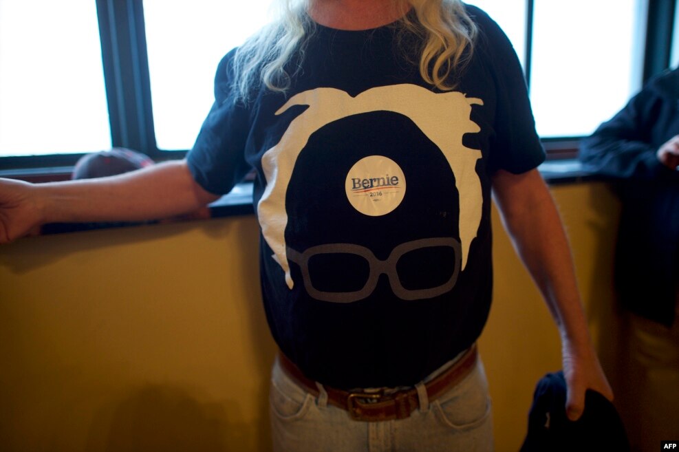 A Bernie Sanders supporter wears a campaign sticker atop his campaign themed t-shirt during a campaign rally at Boardwalk Hall in Atlantic City, New Jersey. Sanders is campaigning in New Jersey ahead of the state's primary on June 7.