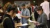 FILE - Job seekers fill out applications in Los Angeles, California, May 31, 2012. 