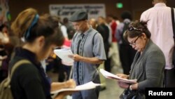 FILE - Job seekers fill out applications in Los Angeles, California, May 31, 2012. 