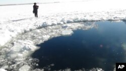 A circular hole in the ice of Chebarkul Lake where a meteor reportedly struck the lake near Chelyabinsk, about 1500 kilometers (930 miles) east of Moscow, February 15, 2013