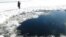 A circular hole in the ice of Chebarkul Lake where a meteor reportedly struck the lake near Chelyabinsk, about 1500 kilometers (930 miles) east of Moscow, February 15, 2013