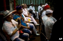 Santeria priests attend the reading of the annual Letter of the Year, written by Afro-Cuban Santeria priests, listing predictions for the new year in Havana, Cuba, Jan. 3, 2017.