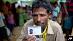 Mohammad Saleem, a Rohingiya man who crossed over to Bangladesh from Myanmar on Sept. 26, 2017, displays an identity card he was issued by the Bangladesh authorities at Kutupalong, Bangladesh, Oct. 1, 2017. 