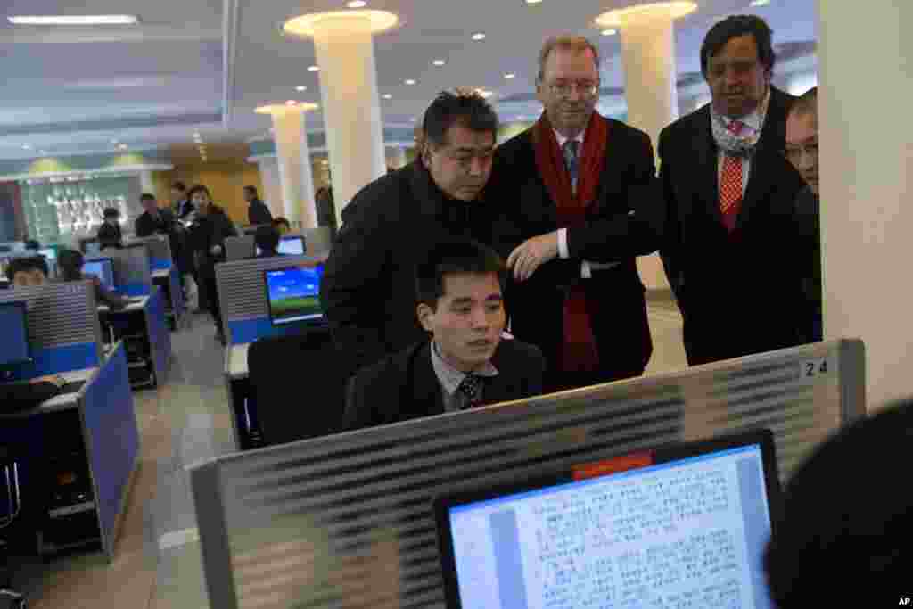 Executive Chairman of Google, Eric Schmidt and former New Mexico governor Bill Richardson watch as a North Korean student surfs the Internet at Kim Il Sung University in Pyongyang, North Korea, January 8, 2013.