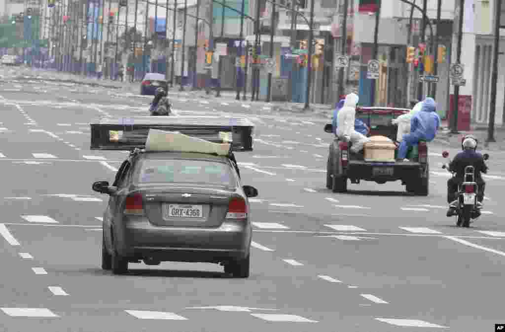 A car and a truck transport coffins containing the remains of people who are believed to have died from complications of the new coronavirus, to a cemetery in Guayaquil, Ecuador, April 11, 2020.