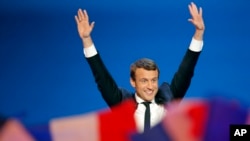 French centrist presidential candidate Emmanuel Macron waves before addressing his supporters at his campaign headquarters in Paris, France, April 23, 2017.