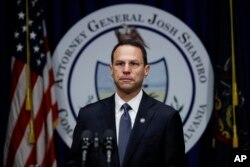 FILE - Pennsylvania Attorney General Josh Shapiro speaks about a grand jury's report on clergy abuse in the Roman Catholic Church during a news conference at the Capitol in Harrisburg, Aug. 14, 2018.