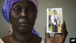 Martha Mark, the mother of kidnapped school girl Monica, cries as she displays her photo, in the family house, in Chibok, Nigeria, in this file photo from May 19, 2014. 