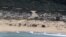 FILE - An aerial view shows Israeli soldiers cleaning tar from the sand after an offshore oil spill drenched much of Israel's Mediterranean shoreline, at a beach in Atlit, Israel, Feb. 22, 2021. 