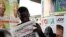Nigerian man read a local newspapers with headlines, Independent National Electoral Commission flops, over a Portrait of Nigeria President Goodluck Jonathan in Lagos, April 3, 2011