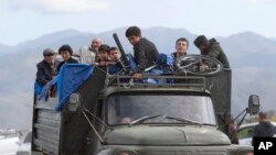 Ethnic Armenians from Nagorno-Karabakh ride a truck on their way to Kornidzor in Syunik region, Armenia, Sept. 26, 2023. Thousands of Nagorno-Karabakh residents are fleeing their homes after Azerbaijan's swift military operation to reclaim control of the breakaway region 