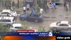 Suspects and bystanders are seen taking selfies after a two-hour car chase through Los Angeles Thursday in this screengrab from KTLA TV.