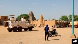 FILE - United Nations forces patrol the streets of Timbuktu, Mali, Sept. 26, 2021.