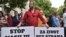 Montenegro man holds banners reading "Stop violence," left, and "For a life without fear," right, during protest in Montenegro's capital, Podgorica, on Wednesday, May 9, 2018. 