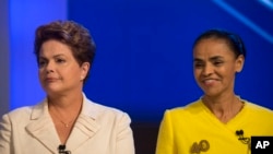 Brazil's President Dilma Rousseff, presidential candidate for re-election of the Workers Party, left, next to Marina Silva, presidential candidate of the Brazilian Socialist Party, as they arrive for a televised presidential debate in Rio de Janeiro, Oct.