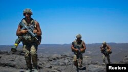 French soldiers patrol in the Terz valley, south of the town of Tessalit in northern Mali, Mar. 20, 2013.