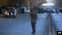 FILE - A policeman stands guard at the site of a suicide attack in central Kabul, Afghanistan, Oct. 31, 2017.