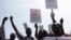 South Sudanese hold banners during a rally in support of President Salva Kiir's administration in Juba, March 10, 2014. 
