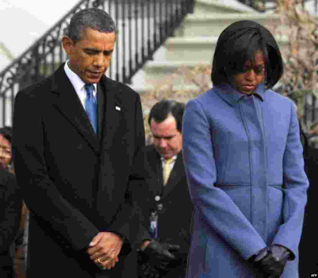 January 10: President Barack Obama, first lady Michelle Obama, and government employees observe a moment of silence on South Lawn of the White House in Washington, to honor those who were killed and injured in the shooting in Tucson, Ariz. Rep. Gabrielle