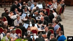 FILE - Participants of the 16th General Assembly of the Synod of Bishops gather in the Paul VI hall at the Vatican, Saturday, Oct. 21, 2023. Pope Francis is convening a global gathering of bishops and laypeople to discuss the future of the Catholic Church. 