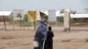 FILE - A mother and daughter walk at the Kakuma refugee camp in northern Kenya, March 5, 2018. 