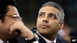 Canadian Al Jazeera English journalist Mohammed Fahmy, listens to his lawyer, Khaled Abou Bakr during his retrial in a courtroom, of Tora prison, in Cairo, Egypt, June 1, 2015.