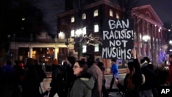 Several hundred people march past the gates of Harvard Yard at Harvard University while protesting the travel ban in Cambridge, Mass., March 7, 2017. 