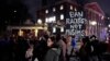 FILE - Several hundred people march past the gates of Harvard Yard at Harvard University while protesting the travel ban in Cambridge, Mass., March 7, 2017. 