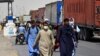 Afghan men walk towards an Afghan-Iran border crossing in Zaranj, Sept. 8, 2021.