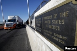 FILE - Trucks wait in the queue for border customs control to cross into U.S. at the Bridge of Americas in Ciudad Juarez, Mexico, Aug. 15, 2017.