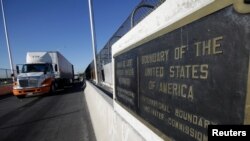 Trucks wait in the queue for border customs control to cross into U.S. at the Bridge of Americas in Ciudad Juarez, Mexico, Aug. 15, 2017.