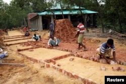 Workers build a Rohingya repatriation center in Gunndum near Cox's Bazar, Bangladesh, Nov. 14, 2018.