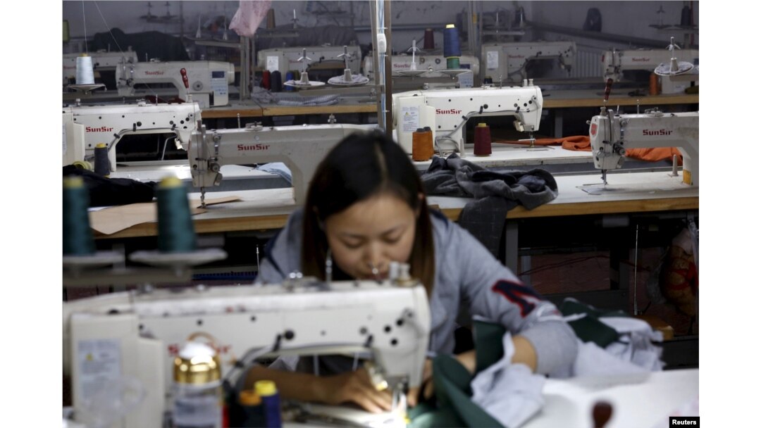 FILE - A woman works in a garment factory in Beijing's Qingyundian industrial zone, Oct. 19, 2015.