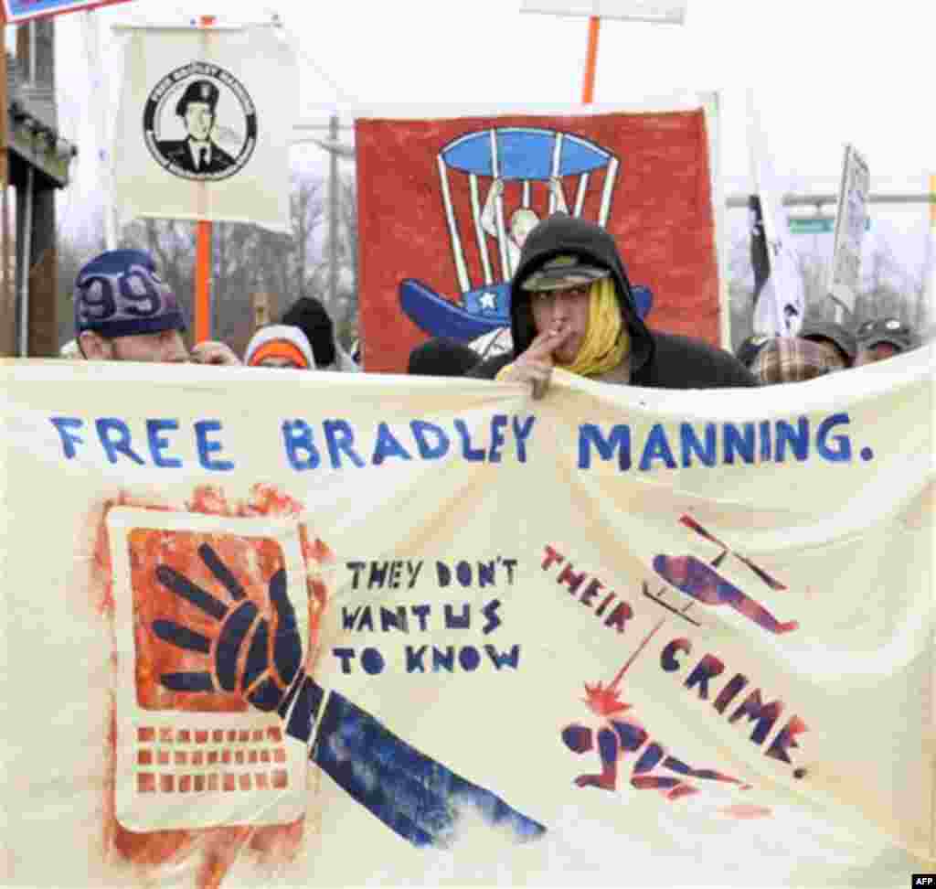 Protestors supporting Pfc. Bradley Manning march outside the gate of Ft. Meade, Md., Friday, Dec. 16, 2011, where Manning will be attending a hearing to determine if he will be court martialed. (AP Photo/Susan Walsh)