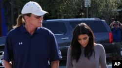 FILE - Kim Kardashian and Bruce Jenner are pictured heading back to their cars after having lunch in West Hollywood, California, Oct. 21, 2014.