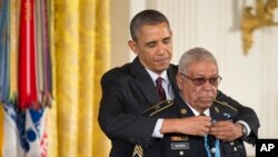 President Obama awards Army Staff Sgt. Melvin Morris the Medal of Honor at the White House.