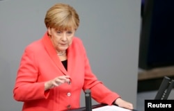German Chancellor Angela Merkel gestures as she delivers the government's declaration on current refugee crisis at the lower house of parliament Bundestag in Berlin, Sept. 24, 2015.