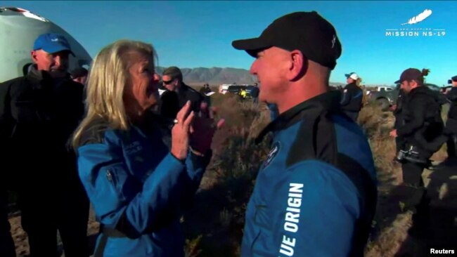 Billionaire Jeff Bezos, founder of ecommerce company Amazon.com Inc, speaks Laura Shepard Churchley, the daughter of the first American in space Alan Shepard and other crew of a Blue Origin New Shepard rocket after their return to Launch Site One in west