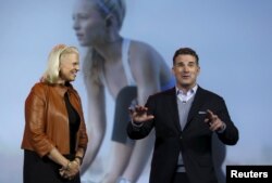 FILE - Ginni Rometty (L), chairman, president and CEO of IBM, listens to Kevin Plank, founder and CEO of Under Armour, during her keynote address at the 2016 CES trade show in Las Vegas, Nevada, Jan. 6, 2016.