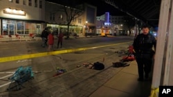 Police canvass the streets in downtown Waukesha, Wis., after a vehicle plowed into a Christmas parade hitting more than 20 people, Nov. 21, 2021.