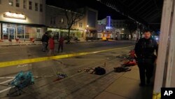 Police canvass the streets in downtown Waukesha, Wis., after a vehicle plowed into a Christmas parade hitting more than 20 people, Nov. 21, 2021.