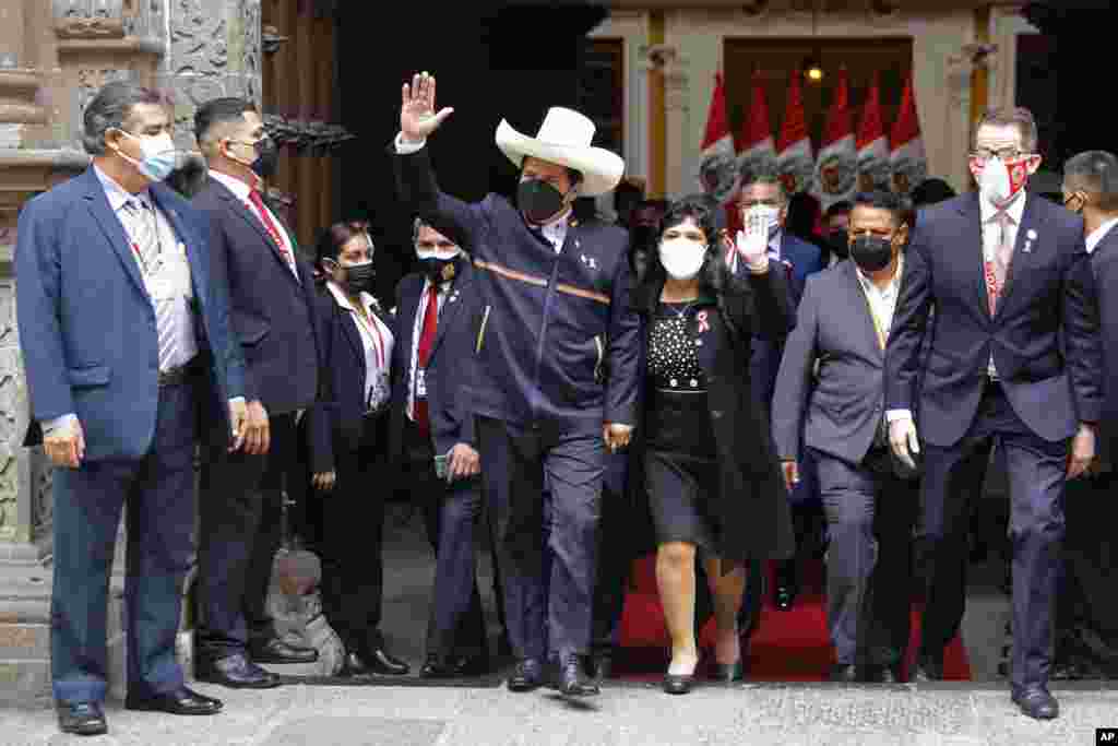 Peru&#39;s President-elect Pedro Castillo and his wife Lilia Paredes wave as they leave the Foreign Ministry to go to Congress for his swearing-in ceremony on his Inauguration Day in Lima, July 28, 2021.