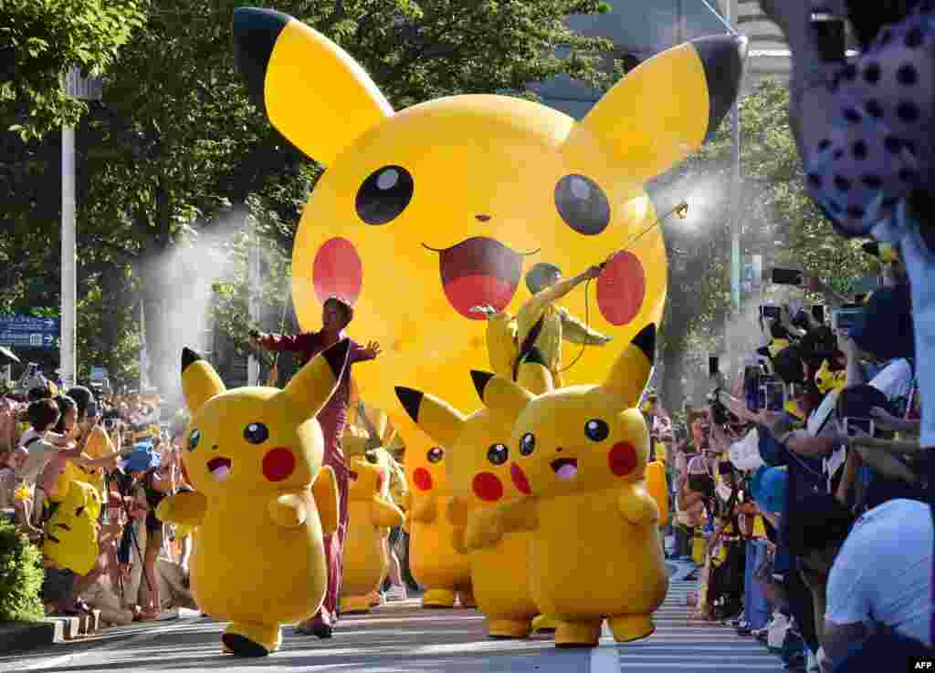 Performers dressed as Pikachu, the popular animation Pokemon series character, perform in the Pikachu parade in Yokohama, Japan.