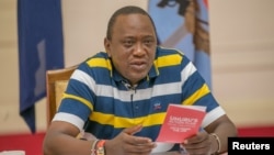 FILE - Kenya's President Uhuru Kenyatta answers questions from the public through Facebook Live at the State House in Nairobi, Kenya, July 23, 2017.