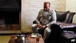 Merhi Alshebli rolls a cigarette in his living room in Juan Lacaze, Uruguay. Last November, locals welcomed Alshebli, his wife and their 15 children, who were fleeing Syria's civil war.